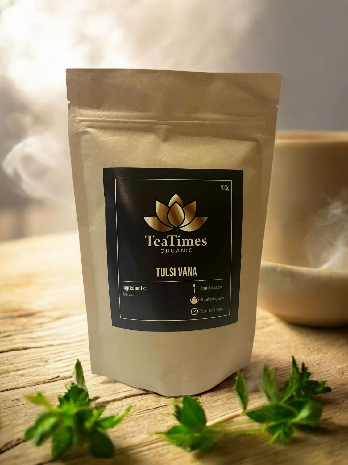 TeaTimes Organic Tulsi Vama package on a wooden surface with green leaves.