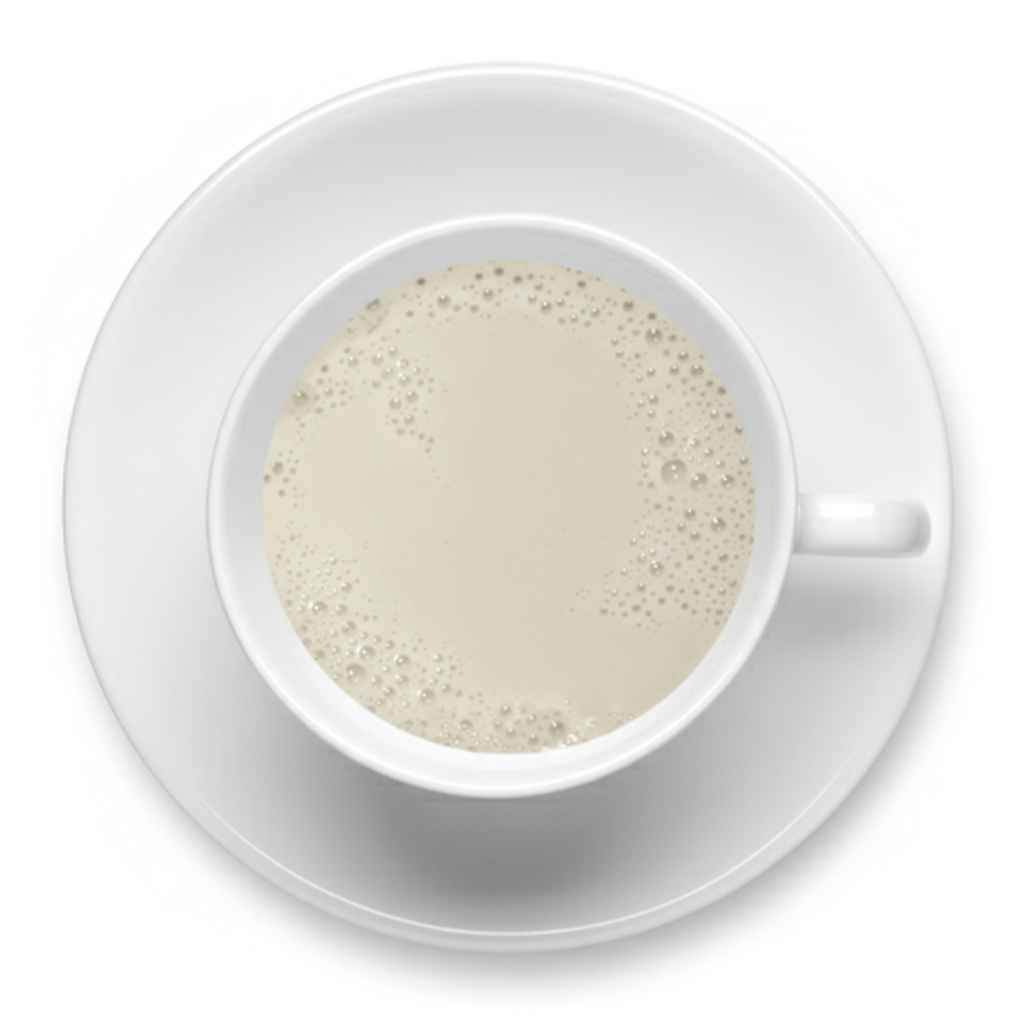 White cup and saucer with a creamy beverage on a white background