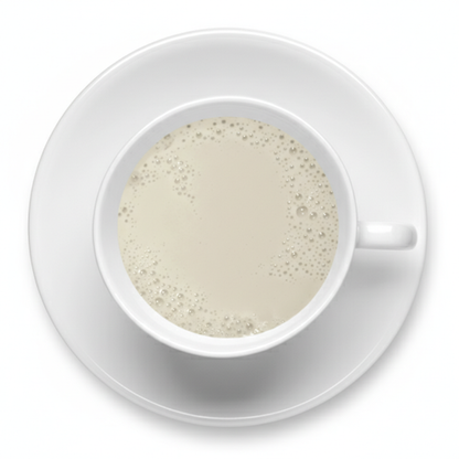 White cup and saucer with a creamy beverage on a white background