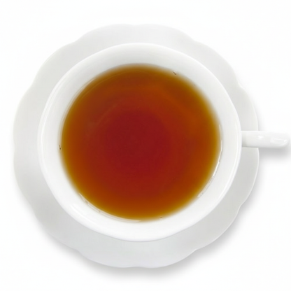 White cup and saucer with a dark liquid on a white background