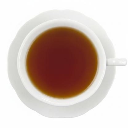 White cup filled with dark liquid on a white background