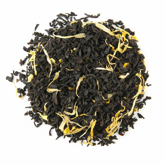 Black tea leaves with yellow strands on a white background